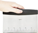 Amazon Basics Multi-Purpose Bench Scraper, Stainless Steel Dough Cutter with Measurement Marks, Dishwasher Safe, Non-slip Contoured Grip, 6", Black, Silver